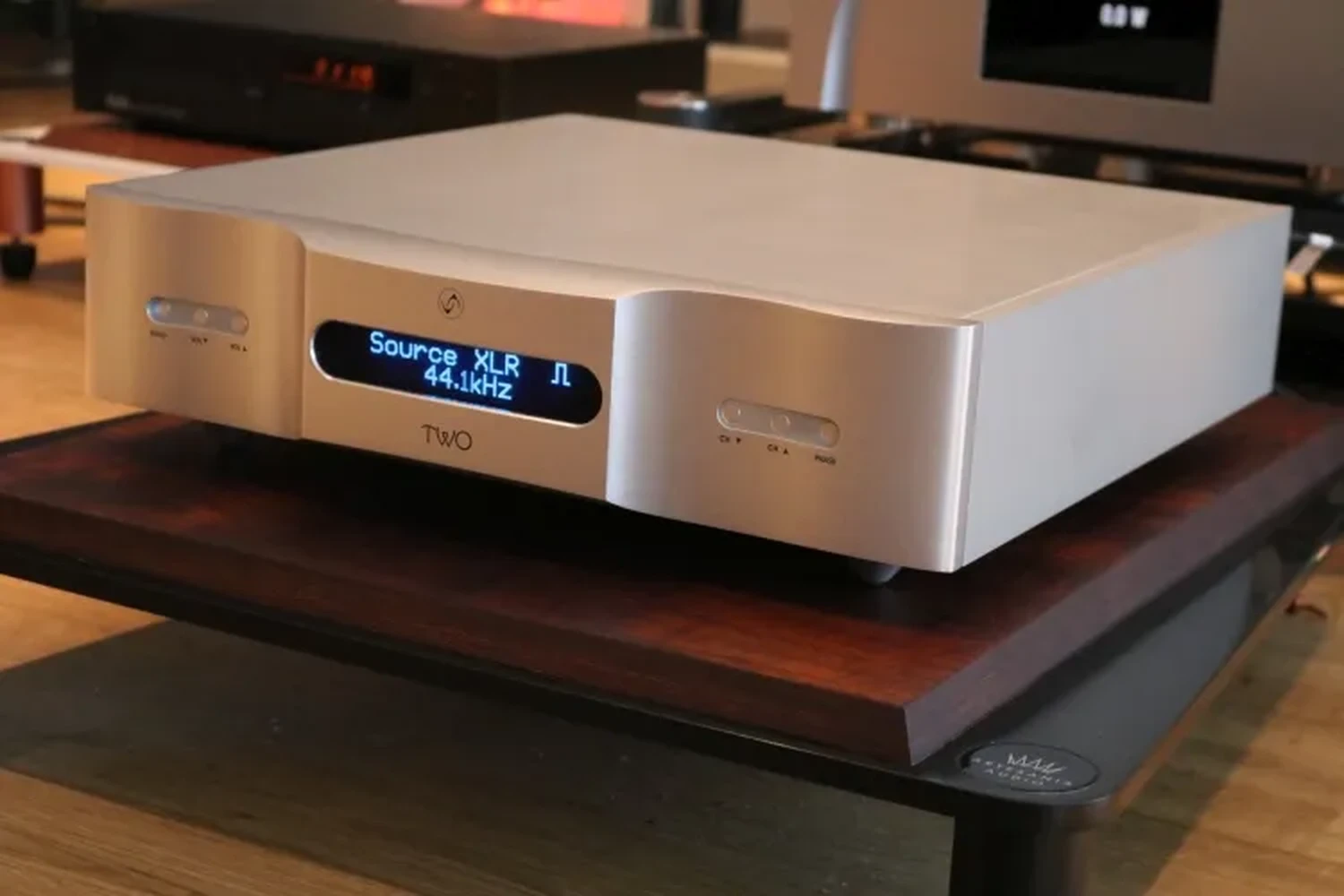 Un DAC Vermeer Audio Two sur une étagère en bois, affichant "Source XLR 44.1khz" sur son écran numérique pendant le test du site Hi-Fi Advice (par 1877.audio)